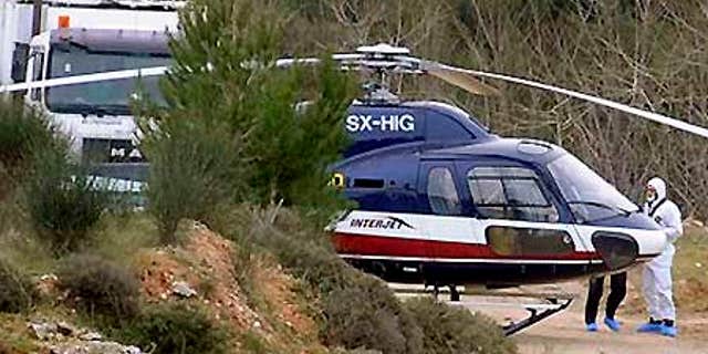 Feb. 22: Forensic experts investigate a helicopter used in the escape of convicts Vassilis Paleokostas and Alket Rizaj from a high-security prison.