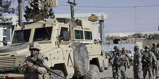 Feb. 15: U.S., Canadian soldiers investigate suspected Taliban militants in Kandahar, Afghanistan.