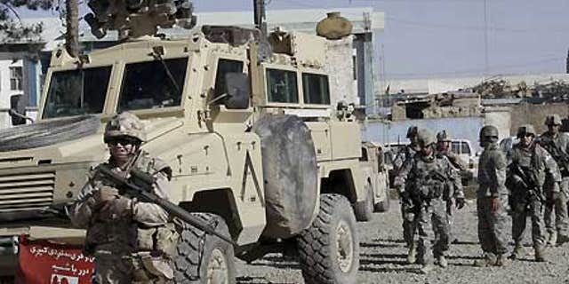 Feb. 15: U.S., Canadian soldiers investigate suspected Taliban militants in Kandahar, Afghanistan.