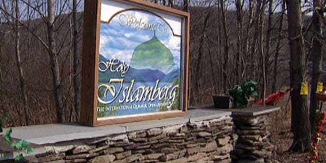 The gate to Islamberg, N.Y., a private Muslim community that is home to an estimated 100 residents. The sign reads: 'Welcome to Holy Islamberg, The International Quranic Open University.'