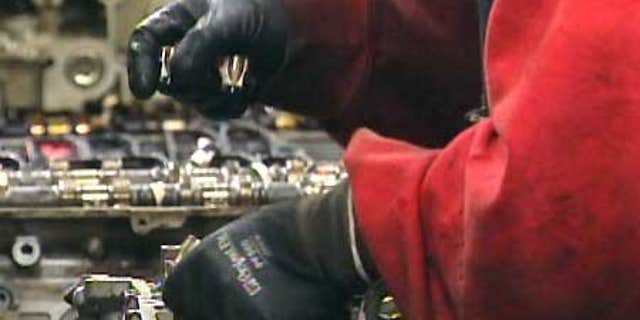 A worker handles parts at a Yamato Engine Specialists plant in Washington where Immigration and Customs Enforcement officials arrested 28 in a February raid.