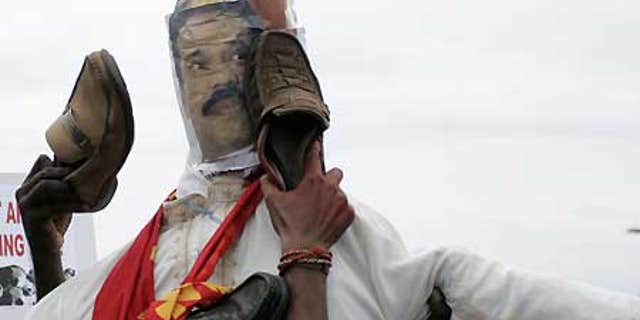 April 21: Malaysian Indian protesters of Tamil ethnicity beat an effigy of Sri Lankan President Mahinda Rajapaksa with shoes.