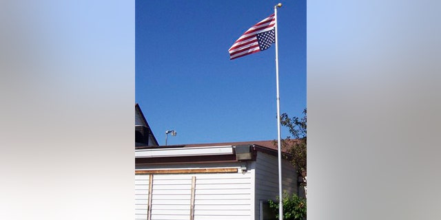July 5, 2009: American flag being flown upside down, a day after it was removed by local police, in Crivitz, Wis.