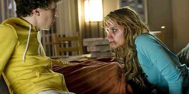 In this film publicity image released by Columbia Pictures, Jesse Eisenberg, left, and Amber Heard are shown in a scene from, "Zombieland."