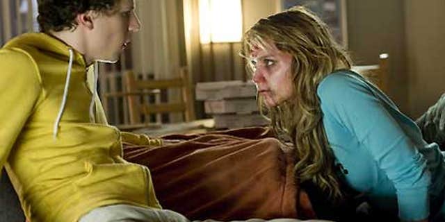 In this film publicity image released by Columbia Pictures, Jesse Eisenberg, left, and Amber Heard are shown in a scene from, "Zombieland."