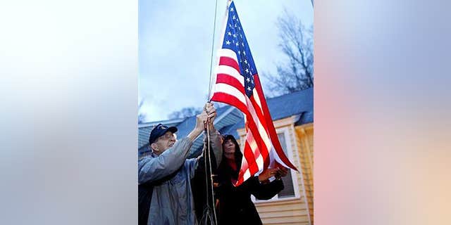 Nov. 2: Col. Van T. Barfoot, 90, and his daughter Margaret Nicholls lower the flag outside Barfoot's home in Henrico County, Va.