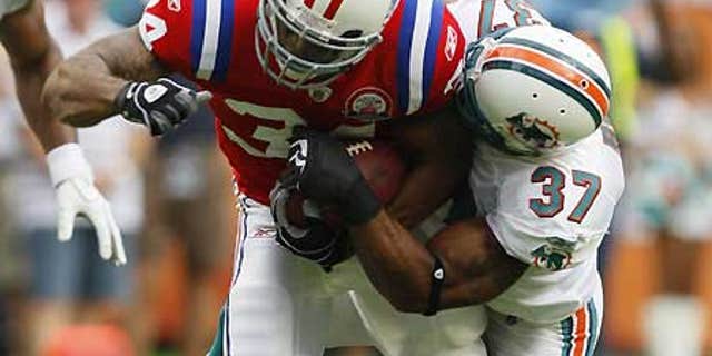 Dec. 6: Miami Dolphins safety Yeremiah Bell (37) tackles New England Patriots running back Sammy Morris (34).