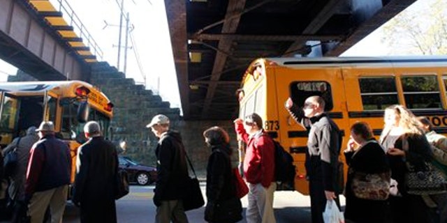 Nov. 4: Stranded commuters are loaded on buses near the scene of a train fire in Philadelphia.