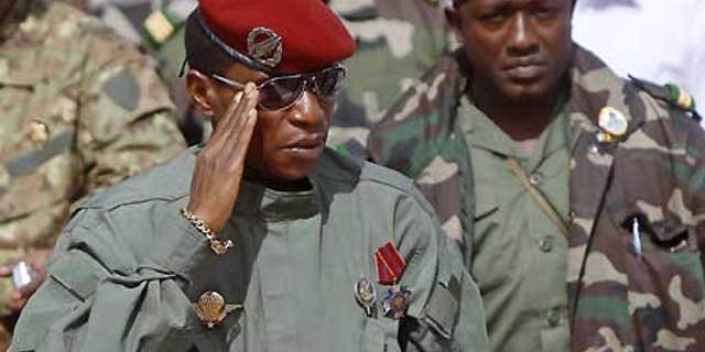 Guinea's military leader, Capt. Moussa "Dadis" Camara, left, salutes next to presidential guard chief Abubakar "Toumba" Diakite, right.