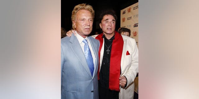 ** FILE ** In this Feb. 20, 2008 file photo, Siegfried Fischbacher, left, and Roy Horn arrive at a party following the premiere performance of Bette Midler's "The Showgirl Must Go On" at Caesar's Palace hotel and casino in Las Vegas. (AP Photo/Isaac Brekken, file)