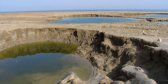 Sinkholes at the Dead Sea's Mineral Beach, in the West Bank, in February 2005.