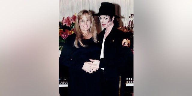November 14, 1996: Pop star Michael Jackson and his new wife Debbie Rowe pose for a wedding photo minutes after the ceremony in California.