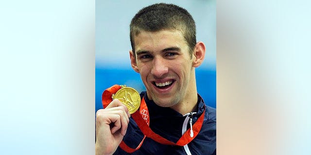 Aug. 17, 2008: Michael Phelps displays his eighth gold medal after the men's 4x100-meter medley relay final at the 2008 Olympic Games in Beijing.