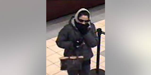 This police handout photo shows a woman police say robbed at least three banks in Long Island.