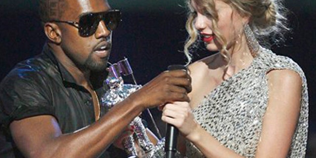 Singer Kanye West takes the microphone from singer Taylor Swift as she accepts the "Best Female Video" award during the MTV Video Music Awards on Sunday, Sept. 13, 2009 in New York. (AP Photo/Jason DeCrow)