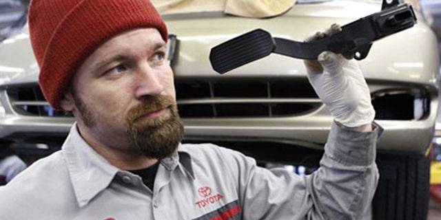 Feb. 3: Mechanic Matthew Lee holds a recalled Toyota gas pedal at a Toyota dealership in Palo Alto, Calif.