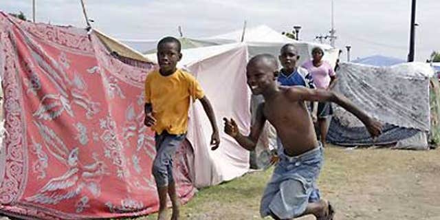 Jan. 26: Boys play in a tent city called Mais Gate near Port au Prince airport.