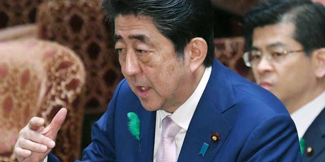 Japanese Prime Minister Shinzo Abe speaks during an Audit and Oversight of Administration Committee session at the lower house of Parliament in Tokyo Monday, April 17, 2017. Abe said Monday that Japan's government is drawing up contingency plans in case a crisis on the Korean Peninsula sends an influx of refugees to Japan. Abe told a parliamentary session that the government is formulating measures including protecting foreigners, landing procedures, building and operating shelters, and screening asylum seekers. (Yoshinobu Shimizu/Kyodo News via AP)