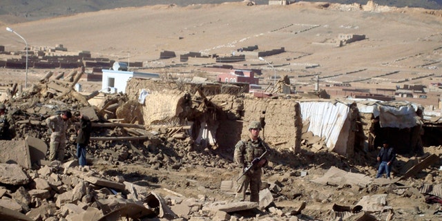 Nov. 23, 2012: A U.S. soldier stands guard at the site of suicide attack in Wardak Province of Kabul Afghanistan.