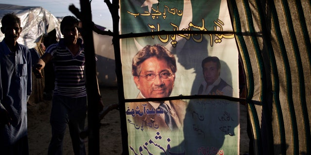 An election banner showing Pakistan's former president and military ruler Pervez Musharraf, is used as a curtain on a makeshift home in a Christian slum on the outskirts of Islamabad, Pakistan, Wednesday, April 17, 2013. Musharraf appeared in court to seek bail in Benazir Bhutto's assassination case. Pakistan's Supreme Court ordered Musharraf to respond to allegations that he committed treason while in power, and barred him from leaving the country only weeks after he returned. (AP Photo/Muhammed Muheisen)