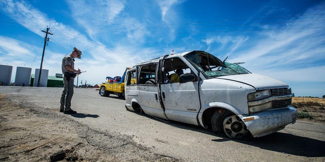 The California Highway Patrol investigate the scene of a single vehicle crash State Route 152 in Merced County, Calif., Saturday, June 20, 2015. Authorities said several farmworkers were killed and others hospitalized after a van overturned on the Central California highway. (Andrew Kuhn/Merced Sun-Star via AP) MANDATORY CREDIT