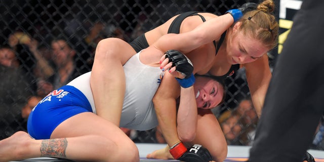 Ronda Rousey, right, grapples with Cat Zingano during a UFC 184 mixed martial arts bantamweight title bout, Saturday, Feb. 28, 2015, in Los Angeles. Rousey won after Zingano tapped out 14 seconds into the bout. (AP Photo/Mark J. Terrill)