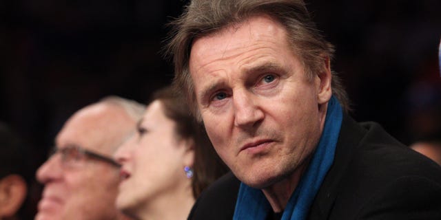Irish actor Liam Neeson sits court side during the first quarter of a game between the New York Knicks and the Miami Heat at Madison Square Garden.