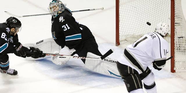 Los Angeles Kings center Anze Kopitar, of Yugoslavia, right, scores a goal past San Jose Sharks goalie Antti Niemi (31), of Finland, and left wing Matt Nieto (83) during the second period of Game 7 of an NHL hockey first-round playoff series in San Jose, Calif., Wednesday, April 30, 2014. (AP Photo)