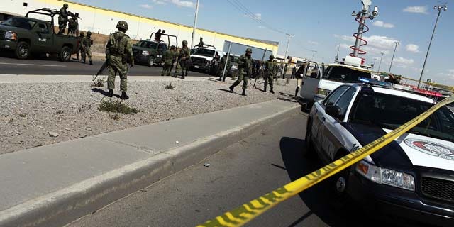 JUAREZ, MEXICO - MARCH 24:  Military police keep guard at the site of a murder on March 24, 2010 in Juarez, Mexico. A Pew Research study found that 61 percent of respondents believe the Mexican and United States' governments were equally to blame for explosion in violence the last few years. (Photo by Spencer Platt/Getty Images)