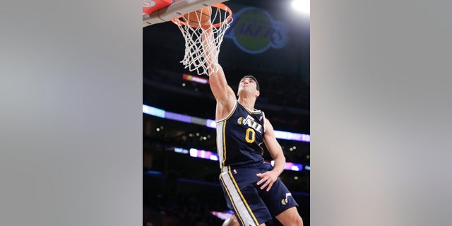 Utah Jazz center Enes Kanter dunks against the Los Angeles Lakers during the first half of a NBA preseason basketball game in Los Angeles, Tuesday, Oct. 22, 2013. (AP Photo/Chris Carlson)