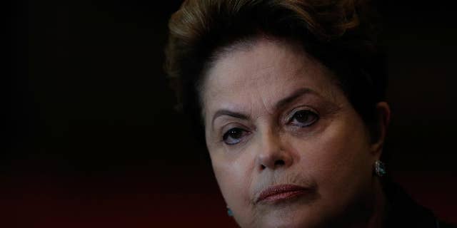 Brazil's President Dilma Rousseff, who is running for reelection with the Workers Party, PT, listens to a question during a campaign news conference at the Alvorada Palace, in Brasilia, Brazil, Monday, Oct. 6, 2014. Official results showed Sunday that President Dilma Rousseff will face challenger Aecio Neves in a second-round vote in Brazil's most unpredictable presidential election since the nation's return to democracy nearly three decades ago. (AP Photo/Eraldo Peres)