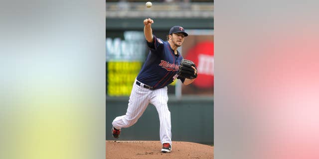 Minnesota Twins’ Phil Hughes throws against the Boston Red Sox during the first inning of a baseball game in Minneapolis, Thursday, May 15, 2014. (AP Photo/Tom Olmscheid)