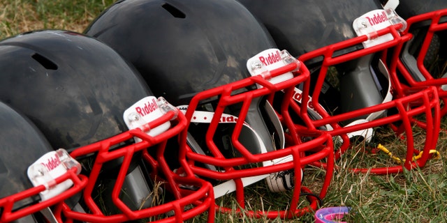 FILE - This Aug. 4, 2012 file photo shows new football helmets that were given to a group of youth football players from the Akron Parents Pee Wee Football League, in Akron, Ohio. It's not just football. A new report says too little is known about concussion risks for young athletes, and it's not clear whether better headgear is an answer. The panel stresses wearing proper safety equipment. But it finds little evidence that current helmet designs, face masks and other gear really prevent concussions, as ads often claim. (AP Photo/Gene J. Puskar, File)