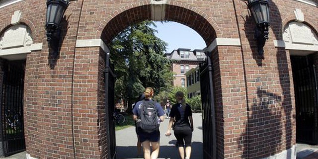 Students walking on Harvard University's campus in Cambridge, Massachusetts.