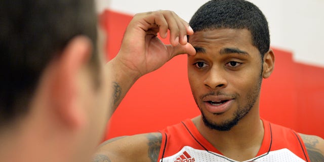 Louisville's Chane Behanan fields questions during NCAA college basketball media day, Saturday, Oct. 12, 2013, in Louisville, Ky. (AP Photo/Timothy D. Easley)