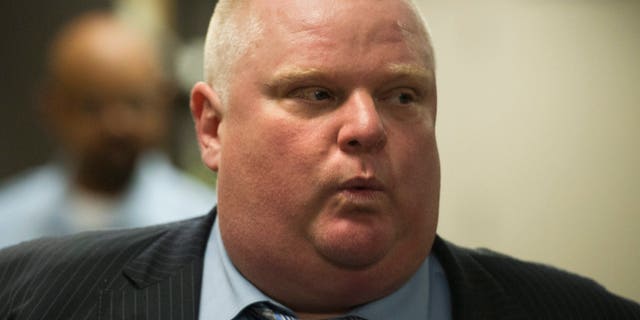 FILE - In this Thursday, May 30, 2013 file photo, Toronto Mayor Rob Ford whistles as he walks to a meeting at city hall in Toronto. Ford, the burly populist who refers to his conservative supporters as "Ford Nation," has transfixed North Americans since published accounts surfaced of a video that apparently shows him puffing from a glass crack pipe. (AP Photo/The Canadian Press, Nathan Denette, File)