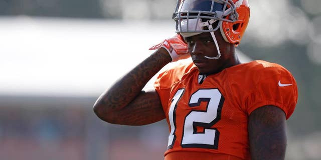 FILE - In this Aug. 4, 2014, file photo, Cleveland Browns wide receiver Josh Gordon rests during practice at the NFL football team's training campin Berea, Ohio. Gordon says the only place he can find peace is on the football field. His time there could be running short. The Browns' star receiver is awaiting word from the NFL on whether he'll be suspended for all or part of the season for violating the league's substance-abuse program. (AP Photo/Tony Dejak, File)