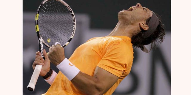 Rafael Nadal of Spain reacts during his match against Ivo Karlovic of Croatia during a quarterfinals match at the BNP Paribas Open tennis tournament in Indian Wells, Calif., Thursday, March 17, 2011. Nadal won 5-7, 6-1, 7-6 (7). (AP Photo/Darron Cummings)