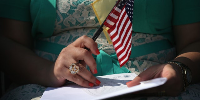 JERSEY CITY, NJ - SEPTEMBER 19: Immigrants prepare to become U.S. citizens at a naturalization ceremony at Liberty State Park on September 19, 2014 in Jersey City, New Jersey. Forty immigrants from 18 different countries became American citizens at the event, held by U.S. Citizenship and Immigration Services (USCIS), on Constitution and Citizenship Day. This week USCIS will have naturalized more than 27,000 new citizens at 160 ceremonies nationwide. (Photo by John Moore/Getty Images)