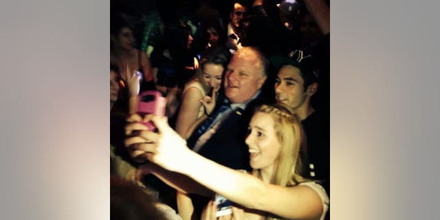 Toronto Mayor Rob Ford poses for photos at the Foggy Dew pub in Coquitlam, British Columbia, late Friday, Jan. 31, 2014. Media reports say Ford was ticketed for jaywalking Friday night. RCMP would not immediately comment to The Canadian Press about the reports, but Global News quoted a witness who said he saw the mayor ticketed. A spokesman for Ford could not immediately be reached for comment. Ford is reportedly in Vancouver for the funeral of a friend's mother. (AP Photo/The Canadian Press, Catriona Korucu)