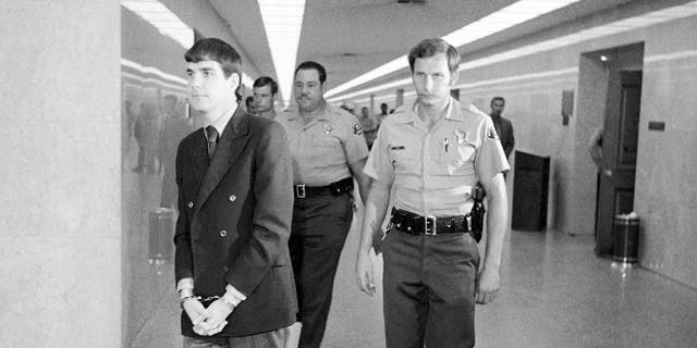 In this Oct. 12, 1971 file photo, Charles "Tex" Watson, left, is led back to jail from a courtroom after he was convicted of seven counts of first degree murder and one of conspiracy to commit murder in the Tate-LaBianca slayings, in Los Angeles. California officials have denied parole for Watson, the self-described "right-hand man" of murderous cult leader Charles Manson. The decision came Thursday, Oct. 27, 2016, at the 17th parole hearing for Watson and 47 years after he helped plan and participated in the slayings of pregnant actress Sharon Tate and six others in 1969. (AP Photo/George Brich, File)