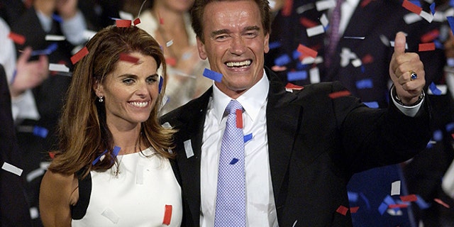 In this file photo taken Oct. 7, 2003, shows Arnold Schwarzenegger and his wife, Maria Shriver ,as they celebrate his victory in the California gubernatorial recall election in Los Angeles.