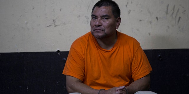 Santos Lopez Alonzo sits in a courtroom as he waits for his first hearing in Guatemala City, Wednesday, Aug. 10, 2016. Lopez Alonzo, former Guatemalan soldier suspected of helping carry out a massacre of more than 160 people in 1982 during the country's civil war was deported from the United States on Wednesday after a court refused his plea to stay because he fears for his life. (AP Photo/Luis Soto)