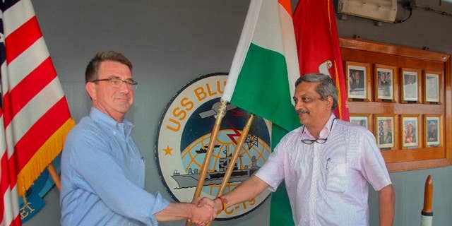 Indian Defence Minister Manohar Parrikar, right, greets US Defense Secretary Ashton Carter during his visit to the Indian Naval Base in Karwar, Karnataka state, India,  Monday, April 11, 2016.(Press Trust of India via AP)INDIA OUT