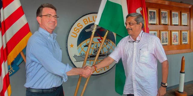 Indian Defence Minister Manohar Parrikar, right, greets US Defense Secretary Ashton Carter during his visit to the Indian Naval Base in Karwar, Karnataka state, India, Monday, April 11, 2016.(Press Trust of India via AP)INDIA OUT