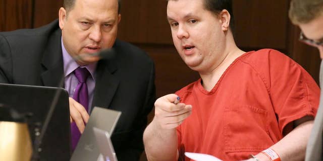 FILE - In this Sept. 15, 2015 file photo, Justin Ross Harris, right, motions to a image on a laptop on the defendant’s tables to one of his attorneys, T. Bryan Limpkin, as the pre-trial motion hearings continue in Marietta, Ga. The trial for Harris, accused of intentionally leaving his toddler son in a hot SUV to die is set to begin Monday, April 11, 2016. Harris is accused of leaving 22-month-old Cooper to die in June 2014. He's been held without bond since then on multiple charges, including murder. His attorneys have called the death a tragic accident. (Kelly J. Huff/Marietta Daily Journal via AP, Pool)