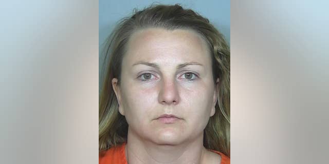This booking photo provided by the Weld County, Colo., Sheriff's Department on Tuesday, May 17, 2016 shows Rachel Einspahr. Investigators say that Einspahr, who was baby sitting two children at the time, robbed a bank in Severance, Colo., on Friday, May 13, 2016, to get cash to pay back money that she stole from two northern Colorado businesses where she worked. (Weld County, Colo., Sheriff's Department via AP)