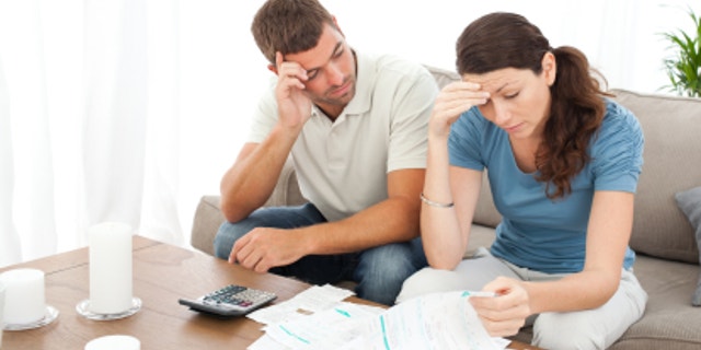 0d623a8e-Worried couple doing their accounts in the living room