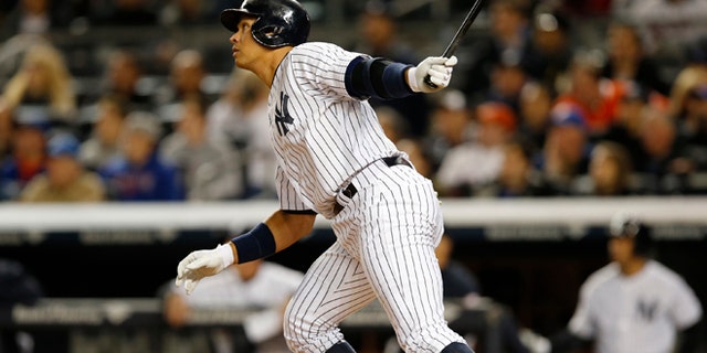 New York Yankees designated hitter Alex Rodriguez (13) hits a first-inning solo home run in a baseball game against the New York Mets at Yankee Stadium in New York, Sunday, April 26, 2015. Rodriguez now stands at 659 career home runs and needs one more to tie Willie Mays. (AP Photo/Kathy Willens)