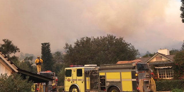 In this photo provided by the Santa Barbara County Fire Department,fire engines provide structure protection at the historic San Ysidro Ranch in Montecito, Calif., Saturday, Dec. 16, 2017.